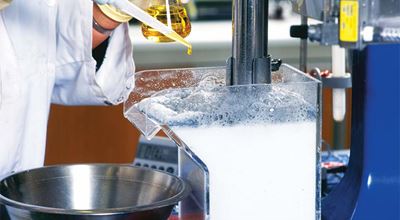 Large yellow trucks in an iron mine.